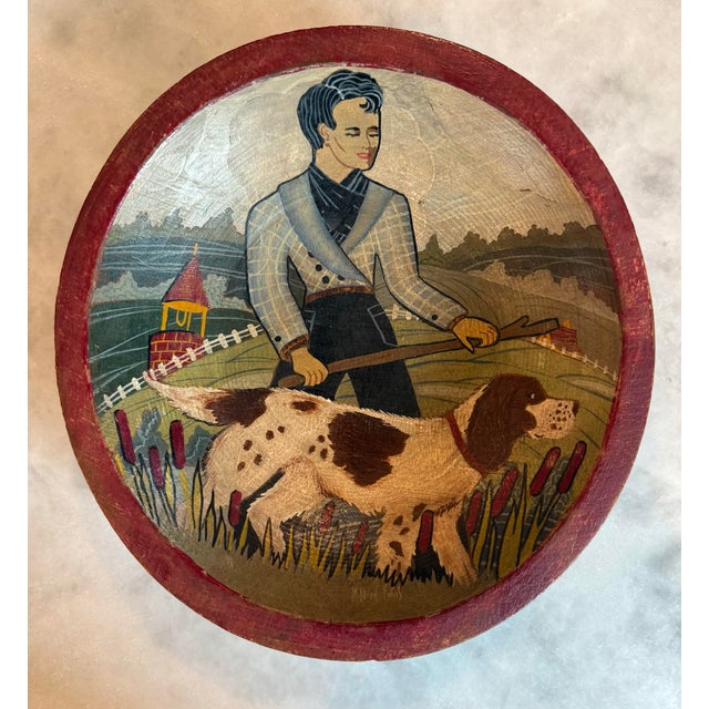 Vintage hand painted wood Munising bowl featuring a stylized folk art painting of a man and dog. Signed by "Mildred Evans".