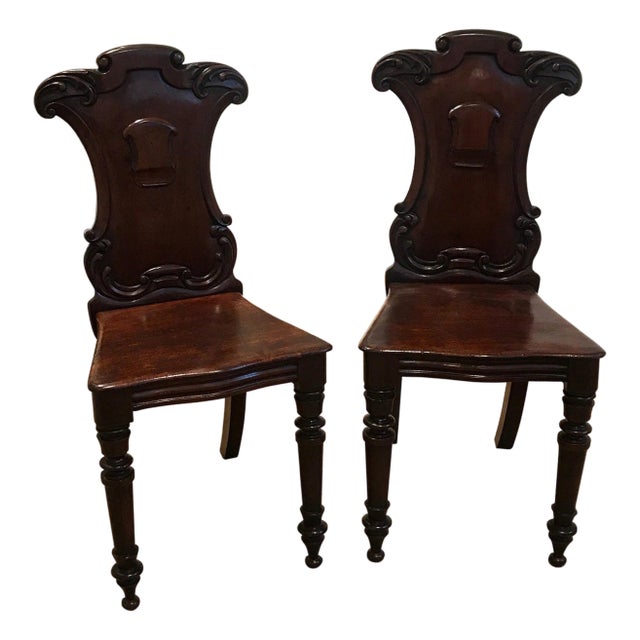 Pair of Hand Carved Mahogany Armorial Hall Chairs For Sale