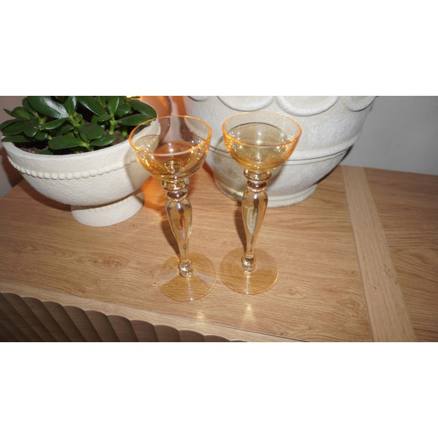 These particular glasses, with their bulbous stems and wide, shallow bowls, are characteristic of coupe glasses, often...