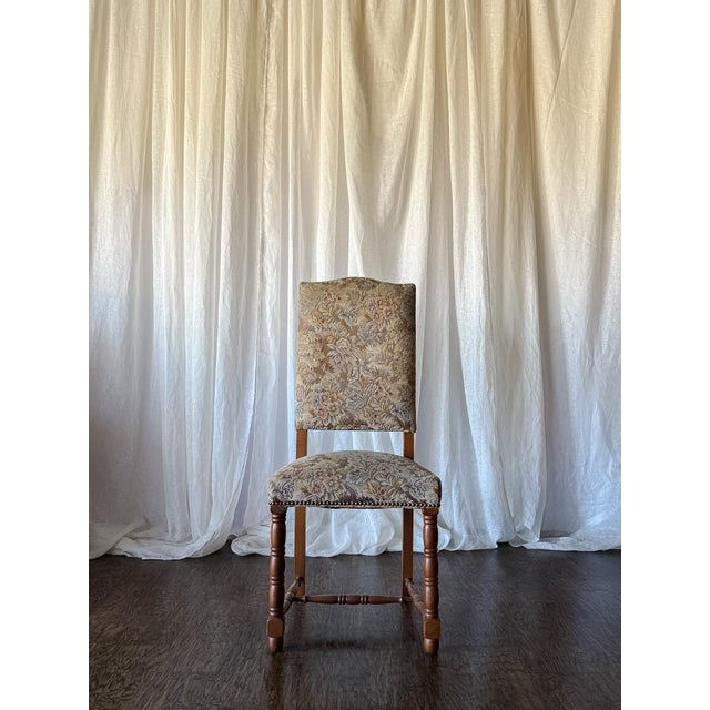 This set of six vintage dining chairs features warm wood frames with beautifully turned legs and stretcher details. The...