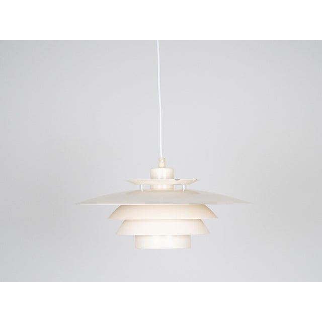A vintage Danish Bless lamp by Dana light. The lamp's form is based on the principle of a reflective system that directs...