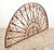 Reclaimed French style arch shaped transom made of wrought iron with a rust exterior. It features a semi circular design...
