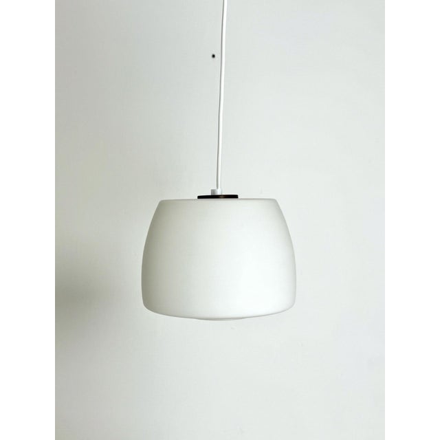 Danish Opaline Glass Pendant Light, 1950s–60s A timeless and understated vintage pendant light from 1950s–60s Denmark....