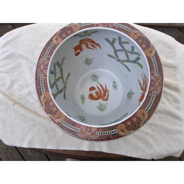 The original light blue sticker on the bottom of this Chinese fish pot reads "Quality Product by Oriental" and refers to...