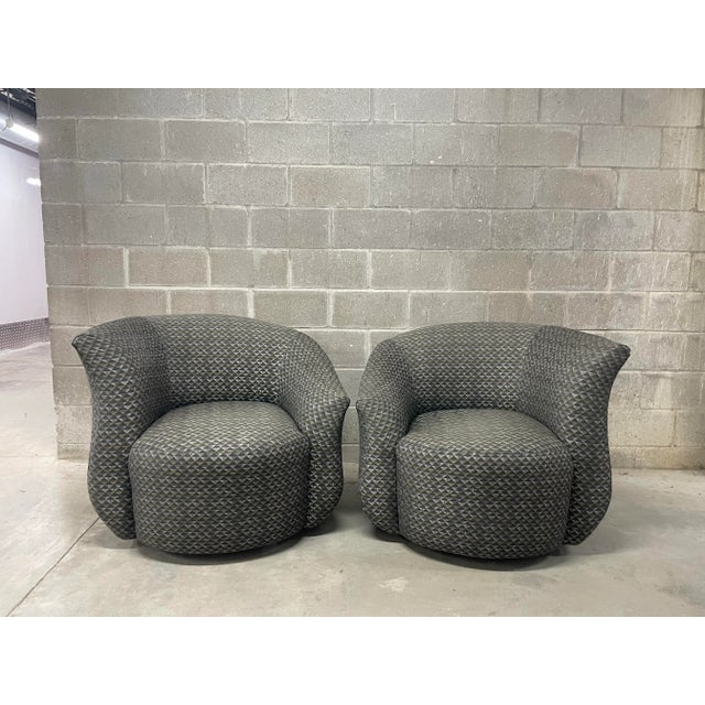 Beautiful Post Modern pair of swivel chairs. Asymmetrical wave barrel back with large cushioned seat envelop you in deep...