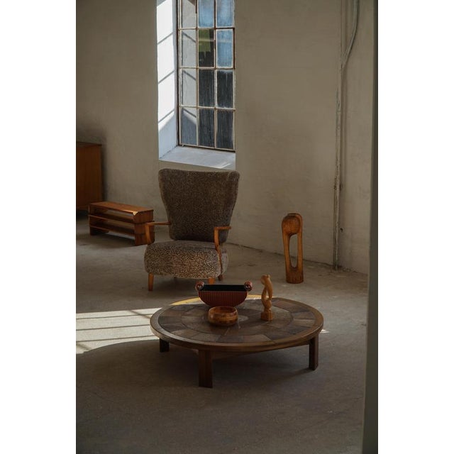 A refined Danish coffee table designed by Tue Poulsen and produced by Haslev Møbelfabrik in the 1970s, exemplifying the...