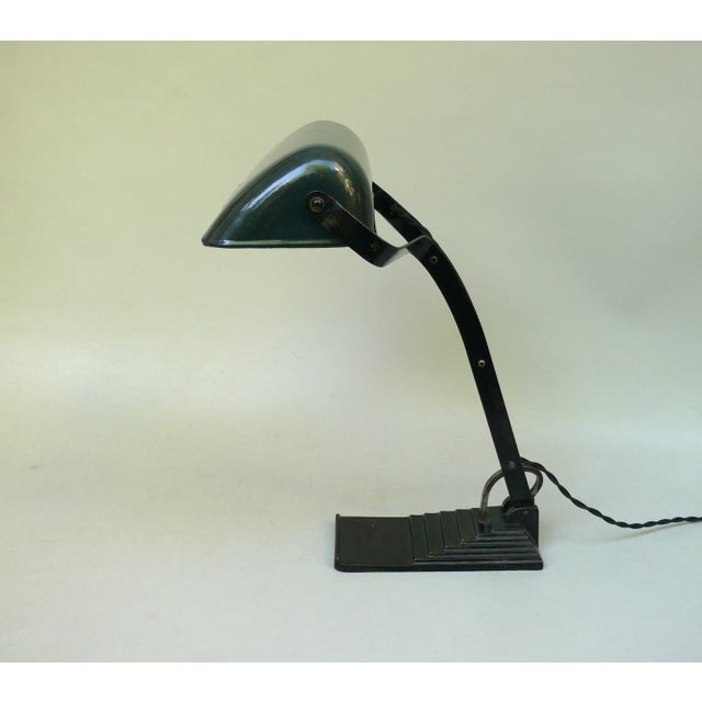 A banker's lamp crafted in a minimalist art deco style with a stepped base, manufactured by dr. Ing. Schneider & co.,...