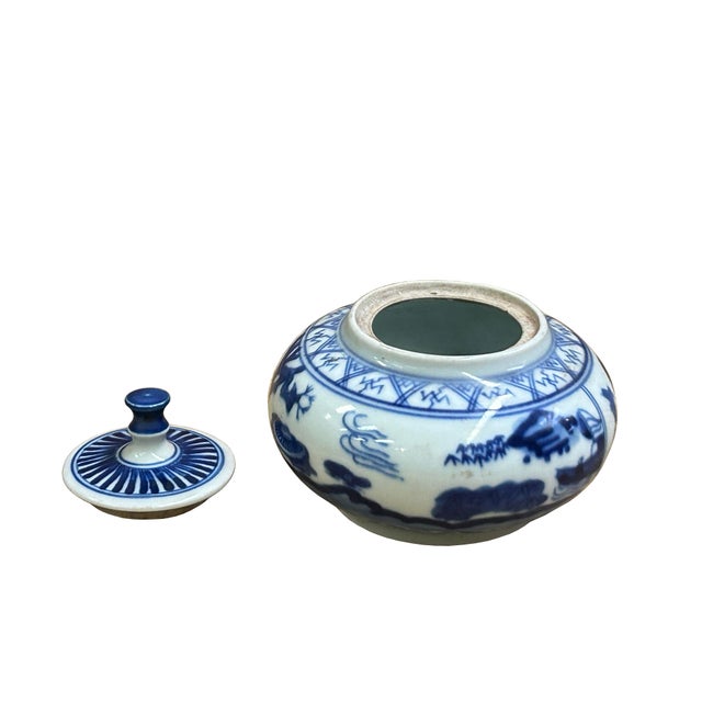 This exquisite, miniature blue and white porcelain jar features a squat, rounded body and a matching domed lid crowned...
