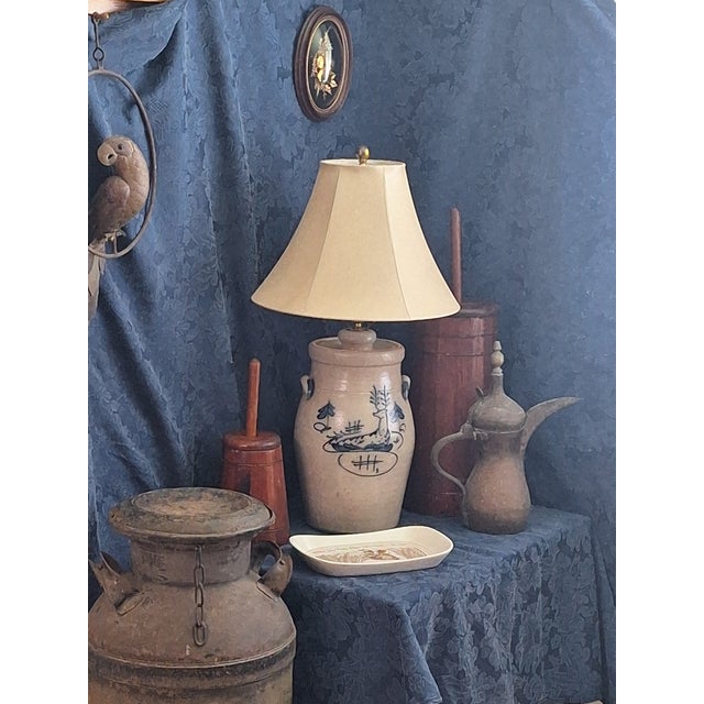 Vintage Ethan Allen stoneware table lamp featuring a hand-decorated deer motif in cobalt blue on a cream speckled crock-...