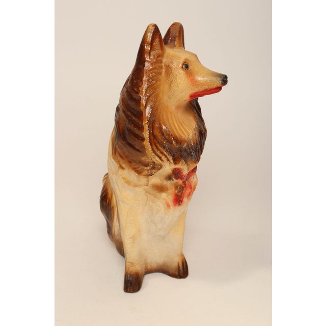 Circa 1940s/50s Outsider Art painted chalkware collie dog figurine in brown and cream with red bow and mouth details...