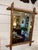 This is a French antique faux-bamboo wall mirror with a hand-carved wood frame. The frame is wood that has been shaped and...