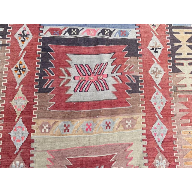 Very beautiful Mid-Century long Kilim, with a geometrical design and nice colors with red, blue, yellow, pink and purple,...