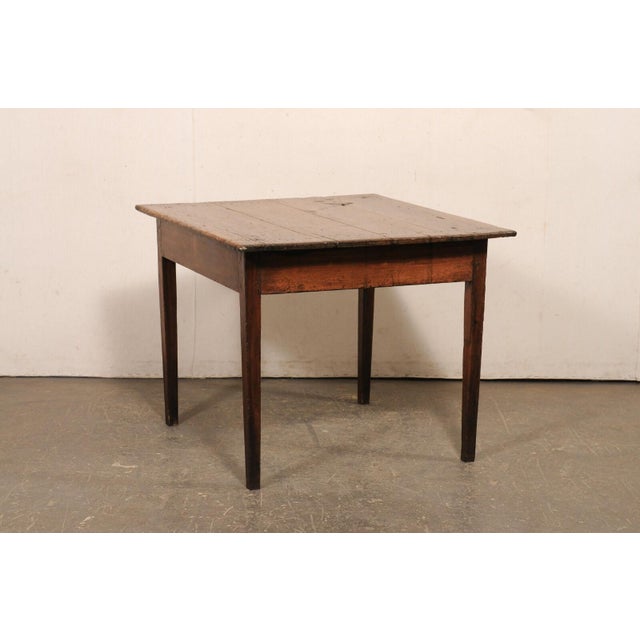 A Brazilian peroba wood table from the 19th century. This antique table from Brazil has a square-shaped top, overhanging...