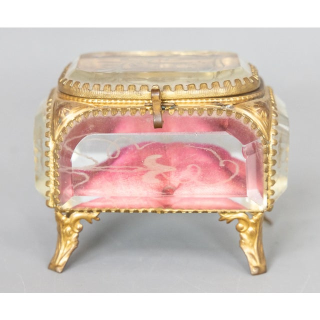 A gorgeous antique 19th Century French ormolu glass trinket box, circa 1860. This miniature box has the original tufted...