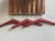 A coat and hat rack made from teak panels separated by steel joints. Manufactured in Denmark in the 80s. The 3 red vinyl...