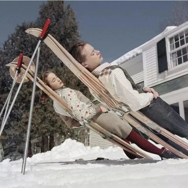New England Skiing 1955 by Slim Aarons Slim Aarons Limited Estate Edition Two women recline on improvised sunbeds in...