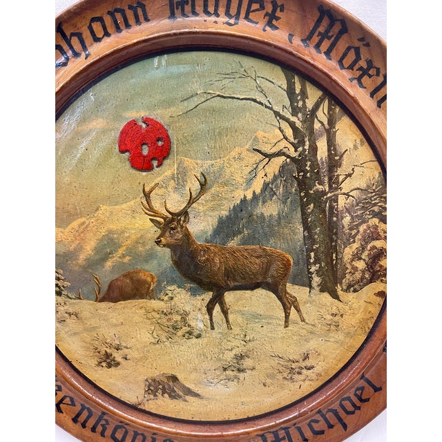 This painted target features a winter stag scene and bullet holes/impacts along with traditional hand-painted script in...