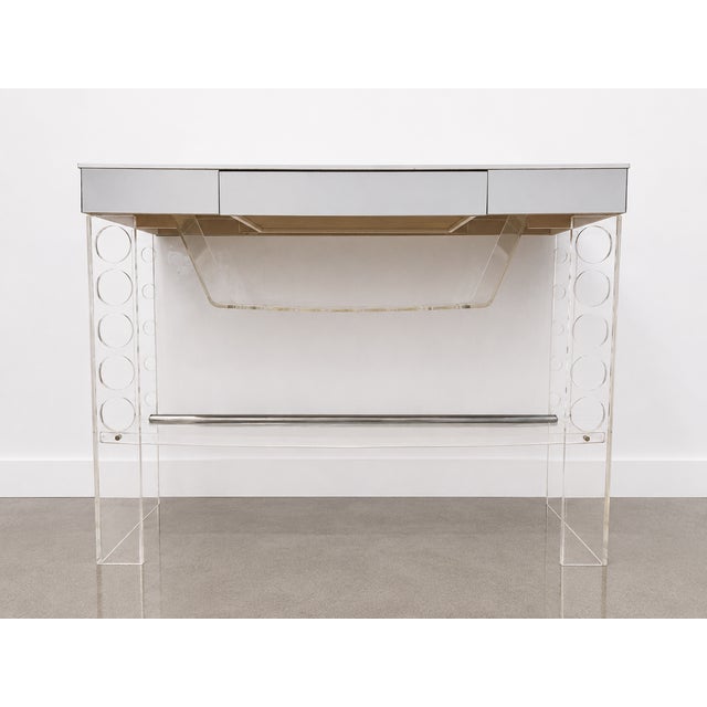Vintage Lucite bar featuring a white laminate top, mirrored drawer fronts and a clear Lucite frame. Decorative circular...