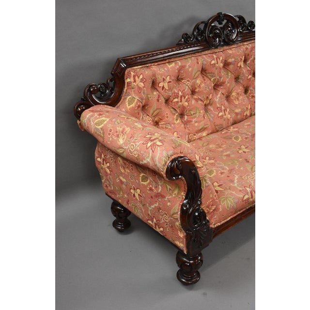 Victorian Carved Mahogany Settee An impressive Victorian mahogany settee, featuring a richly carved show-wood frame and...