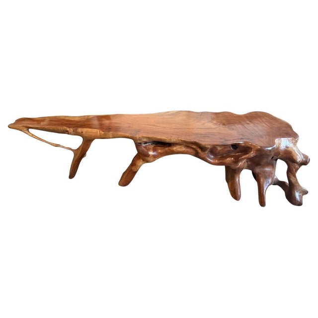 An impressive organic monumental console table carved from a single piece of mahogany wood over a hundred years old. Both...