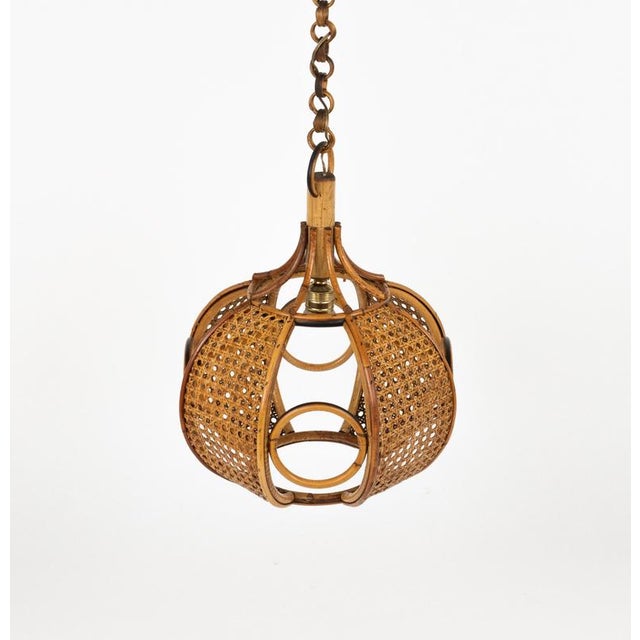 Midcentury beautiful hand-crafted chandelier in rattan and wicker with chain with round rattan links which can be...