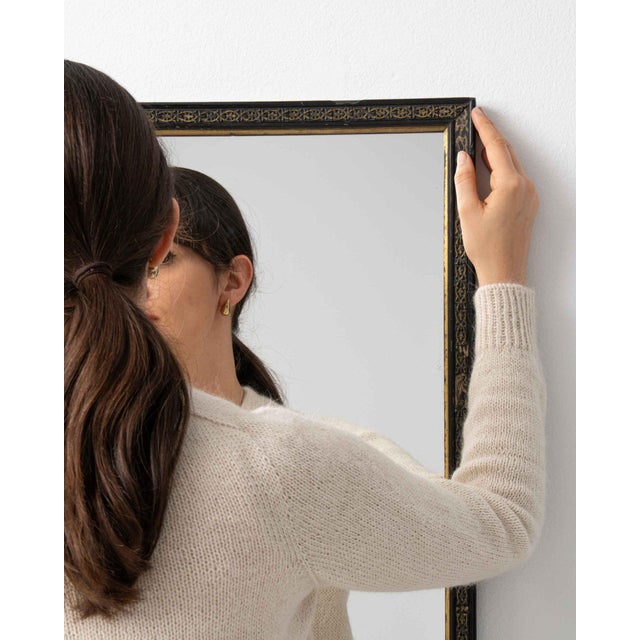 A mirror whose black/gold frame, rectangular gives it real character at first glance. The piece dates to 19th Century,...
