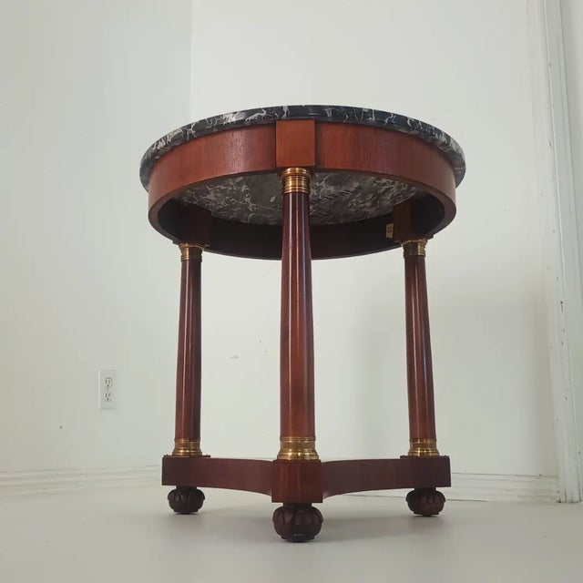 This beautiful side table is from the 70s - 80s. It is built with mahogany wood, brass details and a 3/4 thick marble top....