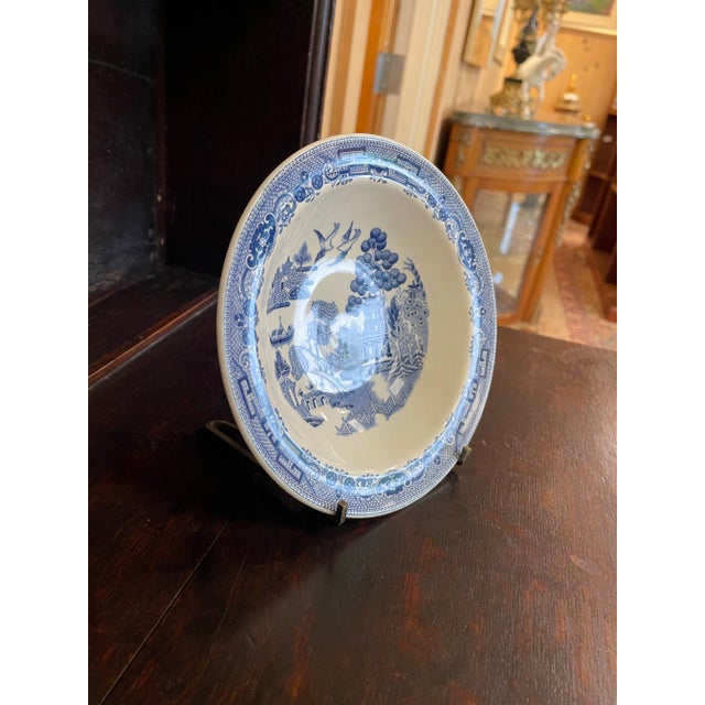 A vintage Blue Willow ironstone cereal bowl crafted in England circa 1940 by Josiah Wedgwood. This 6.5-inch diameter bowl...
