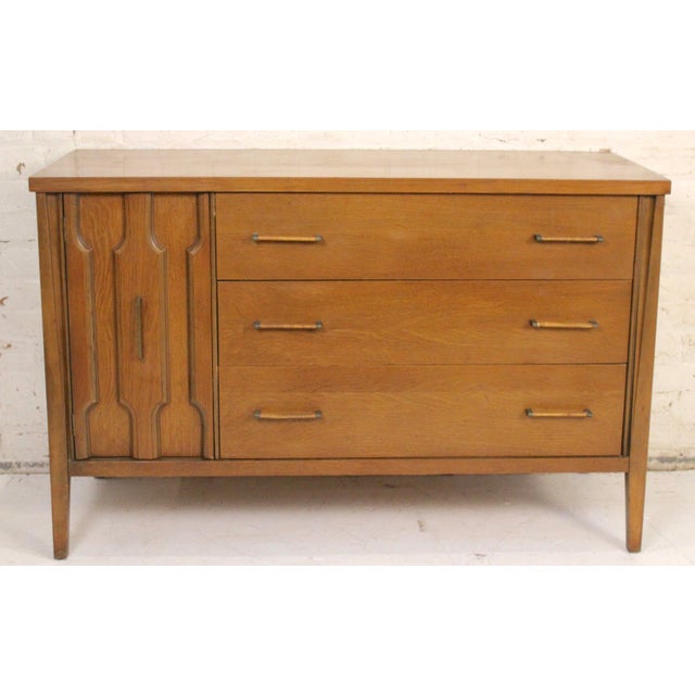 This is a stunning mid-century walnut dresser. This piece features three spacious drawers and a large cabinet. The wicker...