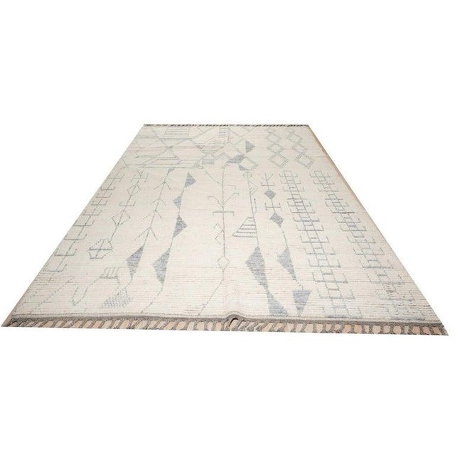 This hand knotted pile rug features a versatile palette of ivory, beige, cream, and white tones. Crafted from natural...