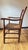 Antique ladder back armchair with a solid wood frame and woven rush seat, dating to the 19th or early 20th century. The...