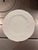 Elegant white bone china bread and butter plates featuring a delicate raised pattern of strawberries, leaves, and trailing...