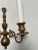 A handsome 1970s cast brass wall sconce designed in the classic Williamsburg style, featuring two gracefully curved arms...