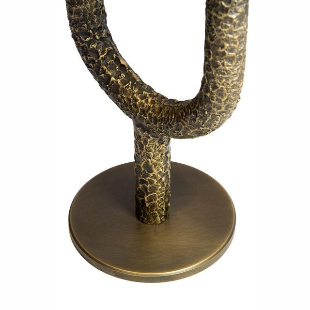 Vega is a two-arm brass candelabra made in Italy, characterized by a clean, continuous form that evokes a classical...