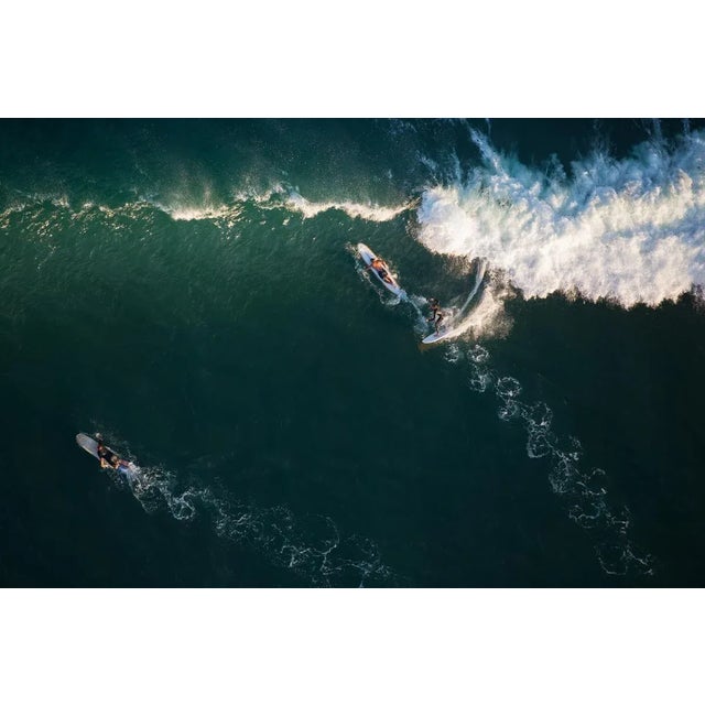 Surfers in Malibu, CA, at sunset