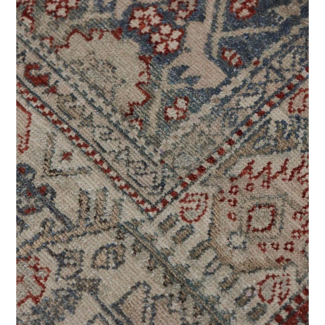 This antique, circa 1900, Malayer rug has a shaded sea-green field with an overall design of linked angular light-grey and...