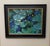 This artwork presents a serene view of a pond, where vibrant green lily pads float gracefully atop deep blue water. The...