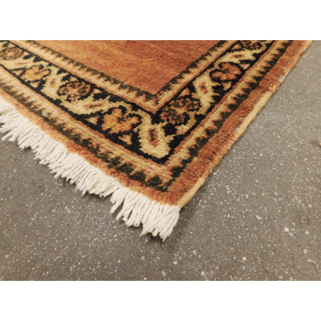 Solid rust field within decorative border. Collection: Antique Persian rug by Nasser Luxury Rugs Size: 3'2"x 15'