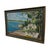 Vintage coastal landscape painting depicting a shoreline scene with a sailboat on calm blue water, a white stucco-style...