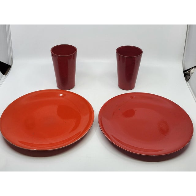 Magnificent and rare set of four pieces in monochrome glazed terracotta, a vibrant and intense red/orange, created by the...