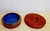 A deeply carved mid-century round cinnabar box with a blue enameled interior and a carved stylized phoenix bird on the...