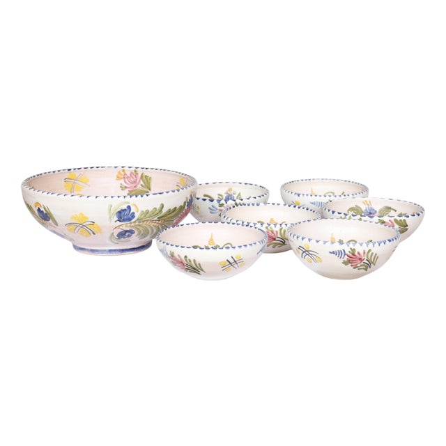 A set of seven hand painted Spanish Talavera bowls, one large and six small. Decorated inside and out with floral sprays...