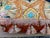 A pair of pillows made from a circa 1920’s hand embroidered crewel work textile, embellished with opulent tassel fringe...