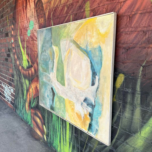 This Mid 20th Century framed abstract painting is by Cleveland, Ohio artist H Norman Schnepf and titled “Emerging Solids...