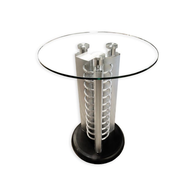 This Postmodern Round Glass and Metal Hightop Accent Table with Chrome Details embodies a bold, architectural aesthetic....