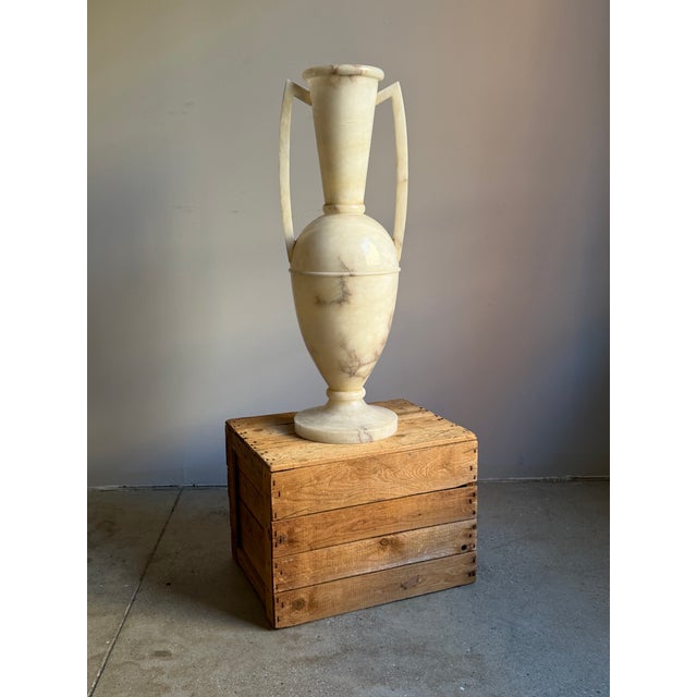 A monumental neoclassical revival alabaster amphora urn lamp. The alabaster stone is warm shades of cream with gray veins...