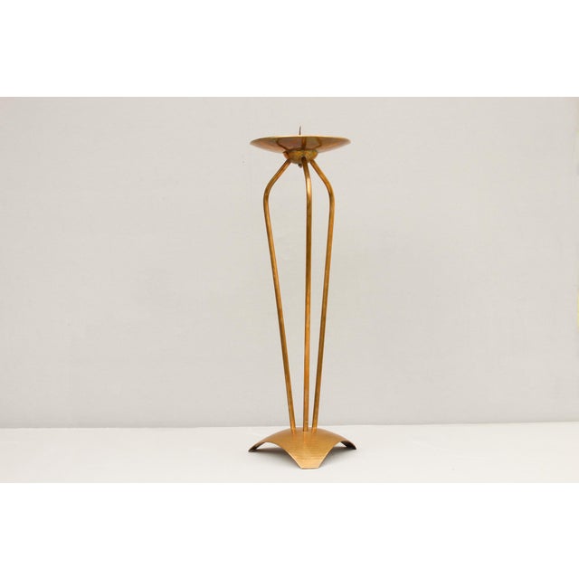 Floor candlestick by Alfred Schäfter (1902–1970), made in Germany around 1930. Hammered brass; the candlestick rests on an...