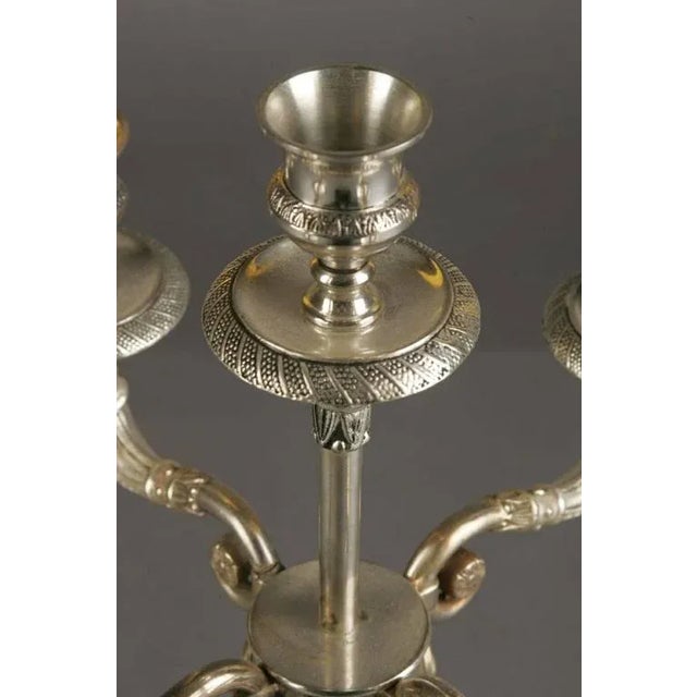 Bronze, finely engraved and antique silvered. Columns as holder for four sweeping candelabra arms.