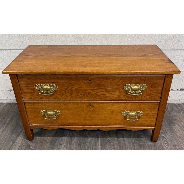 This is a beautiful antique Victorian golden oak two-drawer chest dating to the late 1800s or early 1900s. Features solid...