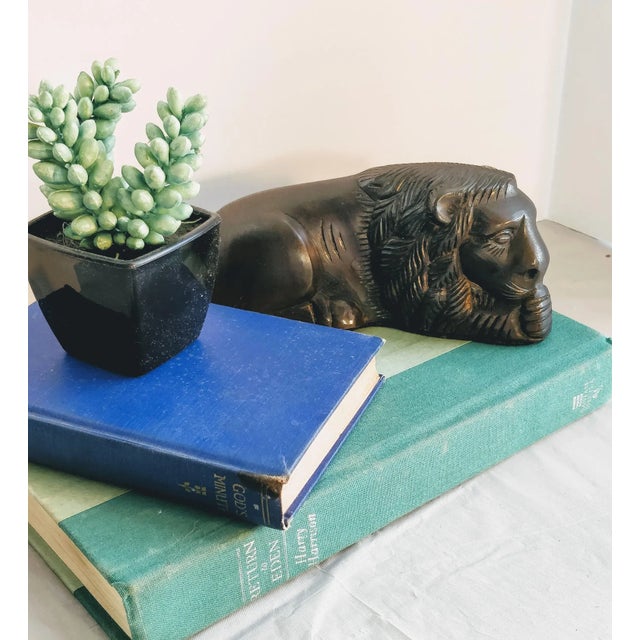 Bronzed metal lion figurine, laying down. Lovely original patina on greatly detailed sleeping lion. Felt on bottom....